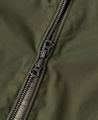 Olive jacket zipper with black pull tab and metal teeth