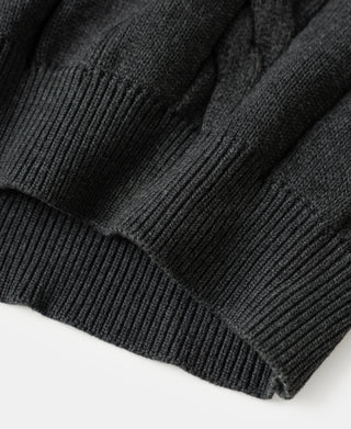Ribbed cuffs and hem of dark gray cable-knit sweater
