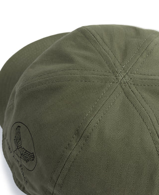 Olive A-3 cap with embroidered shoulder patch and textured fabric stitching