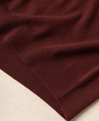 Maroon merino knit fabric fold with visible texture and ribbing
