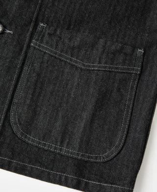 Black denim jacket lower pocket with rounded opening and stitched edge
