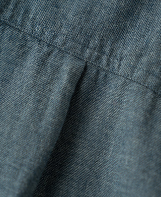 Close-up of blue flannel shirt seam and collar area with fine topstitching.