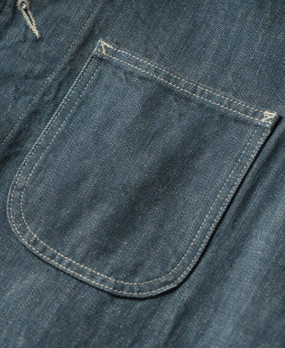 Blue denim barn jacket chest pocket with curved flap and contrast-stitched trim