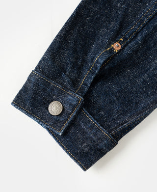 Indigo denim jacket cuff with metal snap and stitched edge