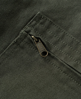 Olive jacket pocket zip with metal pull and textured canvas fabric