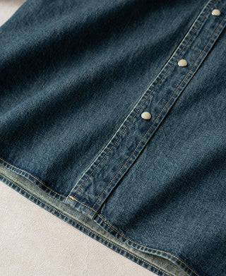 Denim shirt hem with contrast stitching and button details