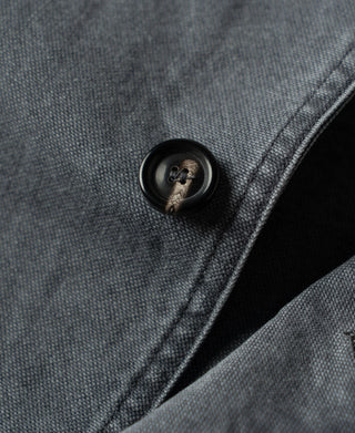Gray-blue canvas jacket with dark button and stitched edge