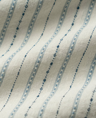 Close-up of white jacquard fabric with varied blue woven stripes