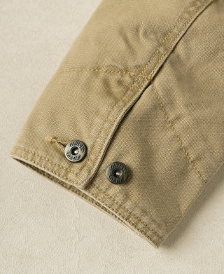 Washed khaki cossack jacket cuff detail with two snap buttons and sewn leather tab