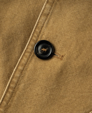 Khaki canvas field jacket with black button and stitched buttonhole