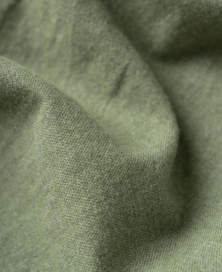 Close-up of sage brushed cotton flannel fabric texture on a work shirt