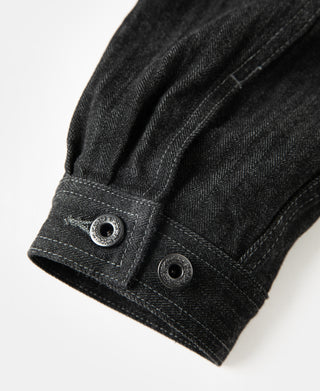 Black denim jacket buttoned cuff with two metal snaps and reinforced seam