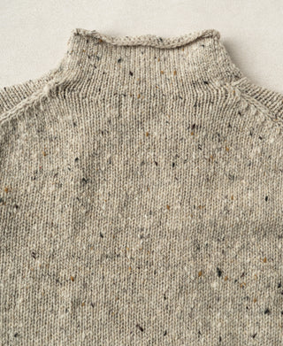 Back view showing the clean silhouette and knit structure of a pure wool fisherman sweater.