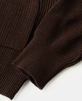 Close-up view of the rib knit texture and structured hem on a coffee wool-blend cardigan sweater.