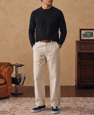 Black crewneck sweater worn by model, front view with ribbed trim