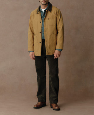 Khaki canvas field jacket worn buttoned over a shirt