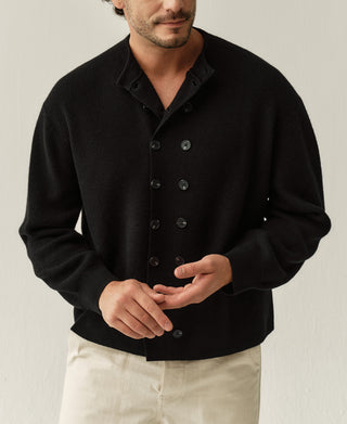 Black knit cardigan with double-breasted button placket and ribbed cuffs