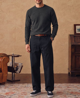 Heather gray merino wool crewneck sweater worn with dark trousers and sneakers
