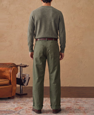 Merino wool crewneck sweater in grayish green, worn with long sleeves and ribbed hem
