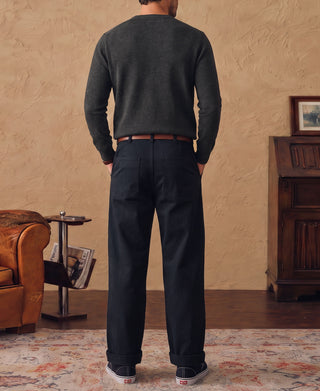 Heather gray merino wool crewneck sweater worn from behind with dark trousers