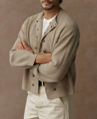 Ecru knit cardigan with buttoned front and folded collar detail