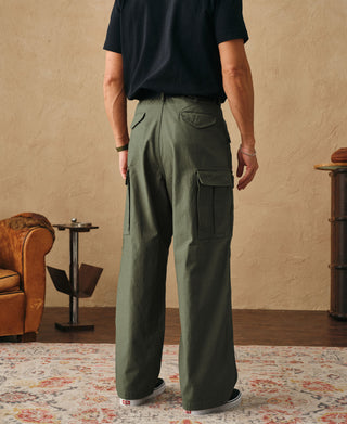 Olive field cargo trousers on model, rear view with pocket detail