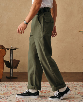 Olive fatigue pants with cuffed ankle, straight leg, and cargo pocket