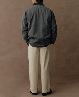Back view of a gray-blue canvas field jacket with a straight hem